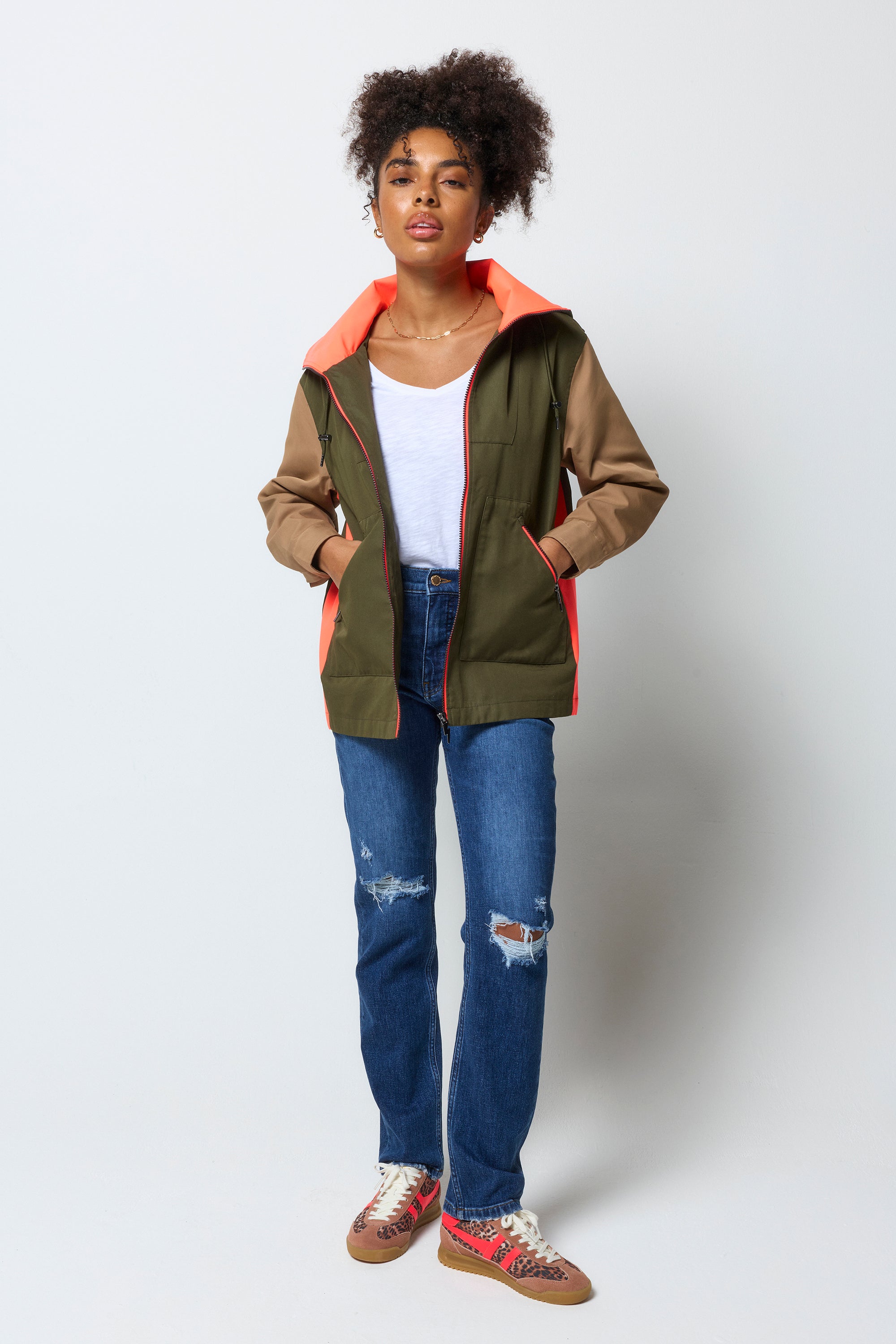 Scamp and Dude Khaki with Camel and Coral Colourblock Short Trench Coat | Model wearing a colourblock short trench coat with distressed jeans and a white v-neck t-shirt.