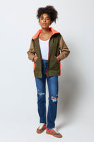 Scamp and Dude Khaki with Camel and Coral Colourblock Short Trench Coat | Model wearing a colourblock short trench coat with distressed jeans and a white v-neck t-shirt.