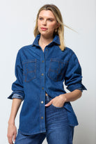 Scamp & Dude Mid Wash Indigo Relaxed Denim Shirt | Model wearing a dark blue denim shirt and distressed jeans.