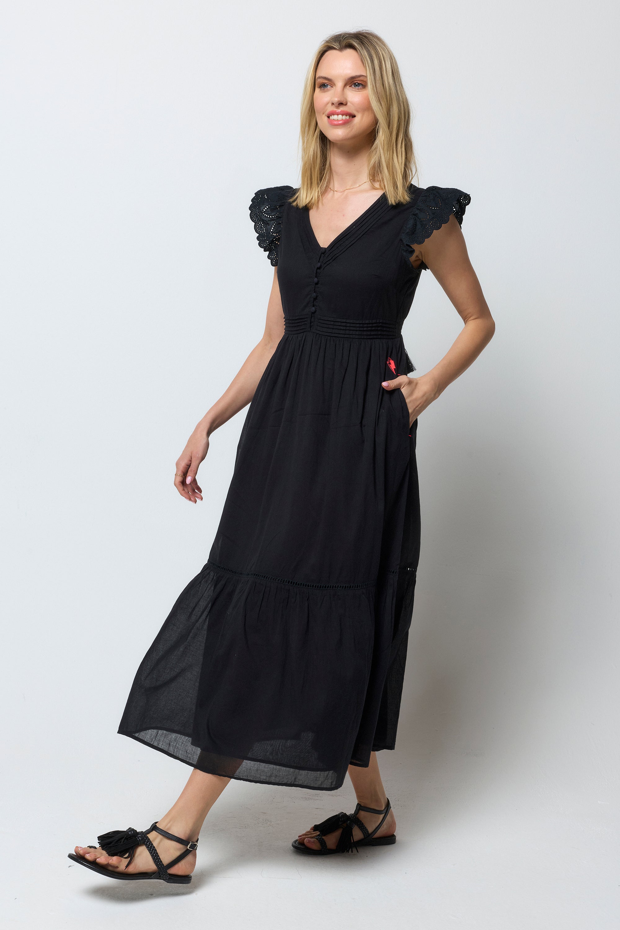 Scamp and Dude Black Broderie Sleeve Pintuck Midi Dress | Model wearing a black midi dress with broderie sleeve detail. Worn with black sandals.
