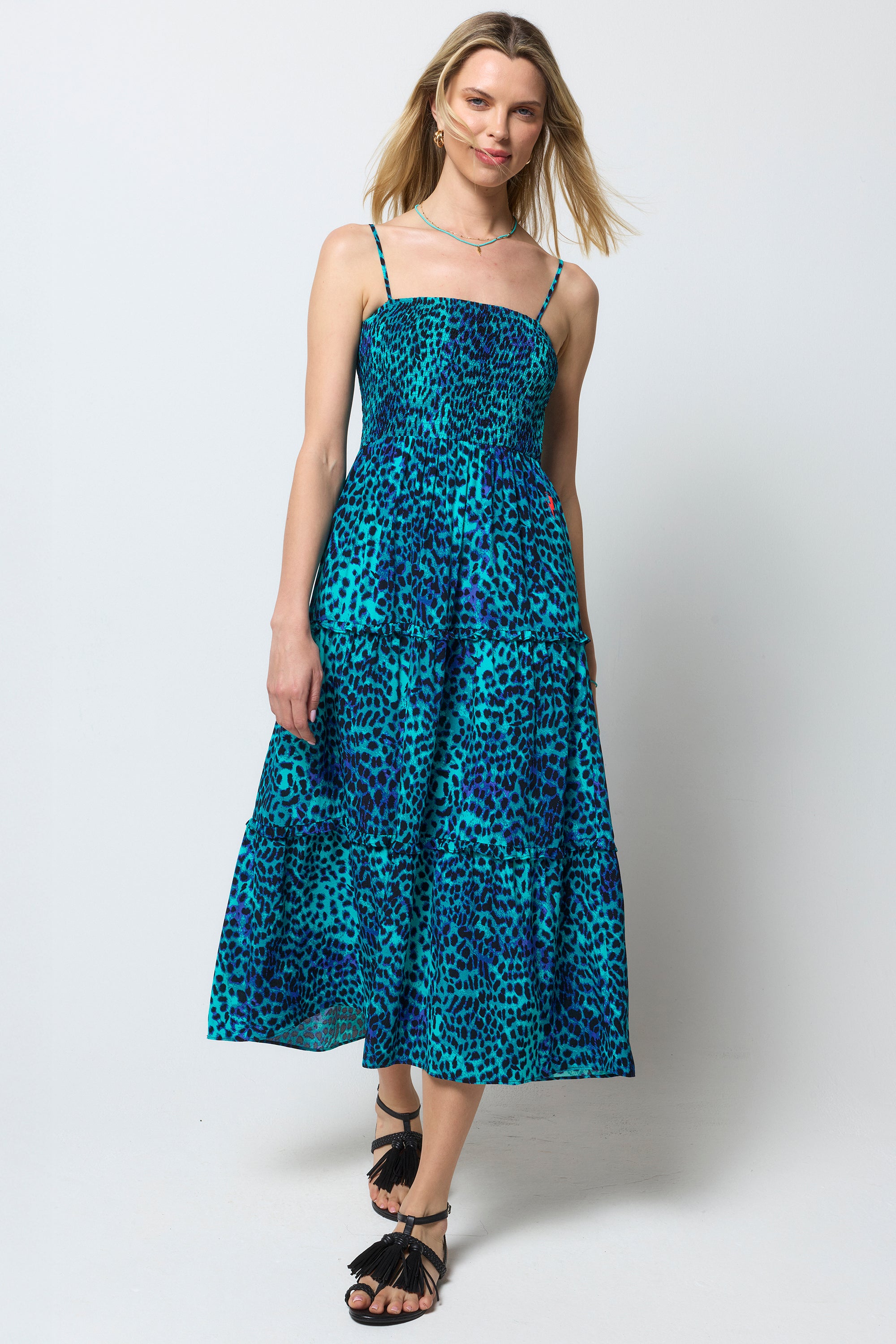 Scamp and Dude Turquoise with Blue Cheetah Bandeau Midi Dress | Model wearing a turquoise bandeau dress with cheetah print. Worn with black sandals.
