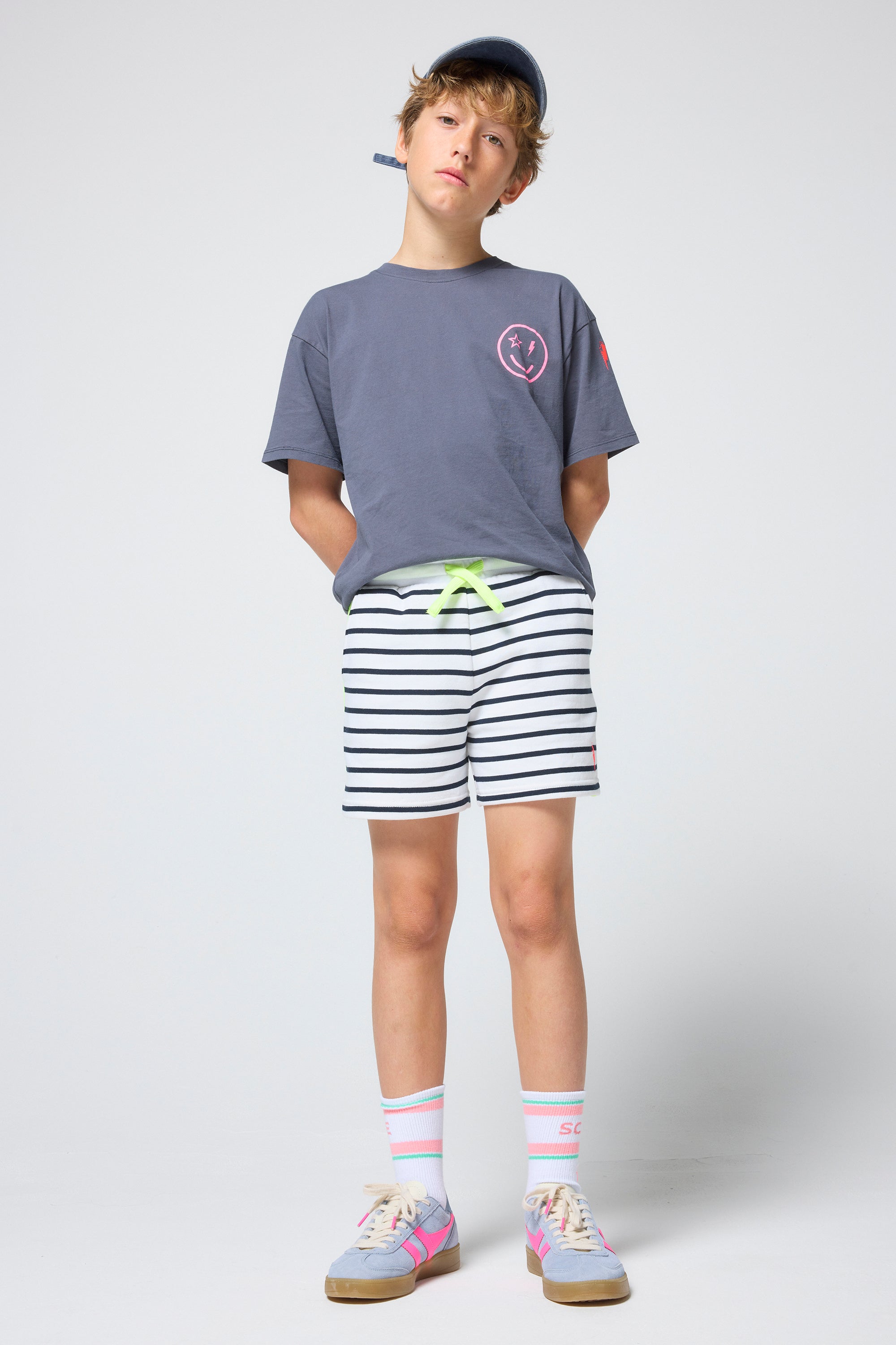 Scamp and Dude Kids Navy Stripe Colourblock Shorts | Model wearing a grey t-shirt and stripe shorts.