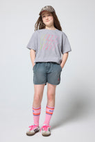 Scamp & Dude Kids Grey Marl Multi Neon Bolt T-Shirt | Model wearing a grey t-shirt, shorts, and trainers with colourful socks on a white background.
