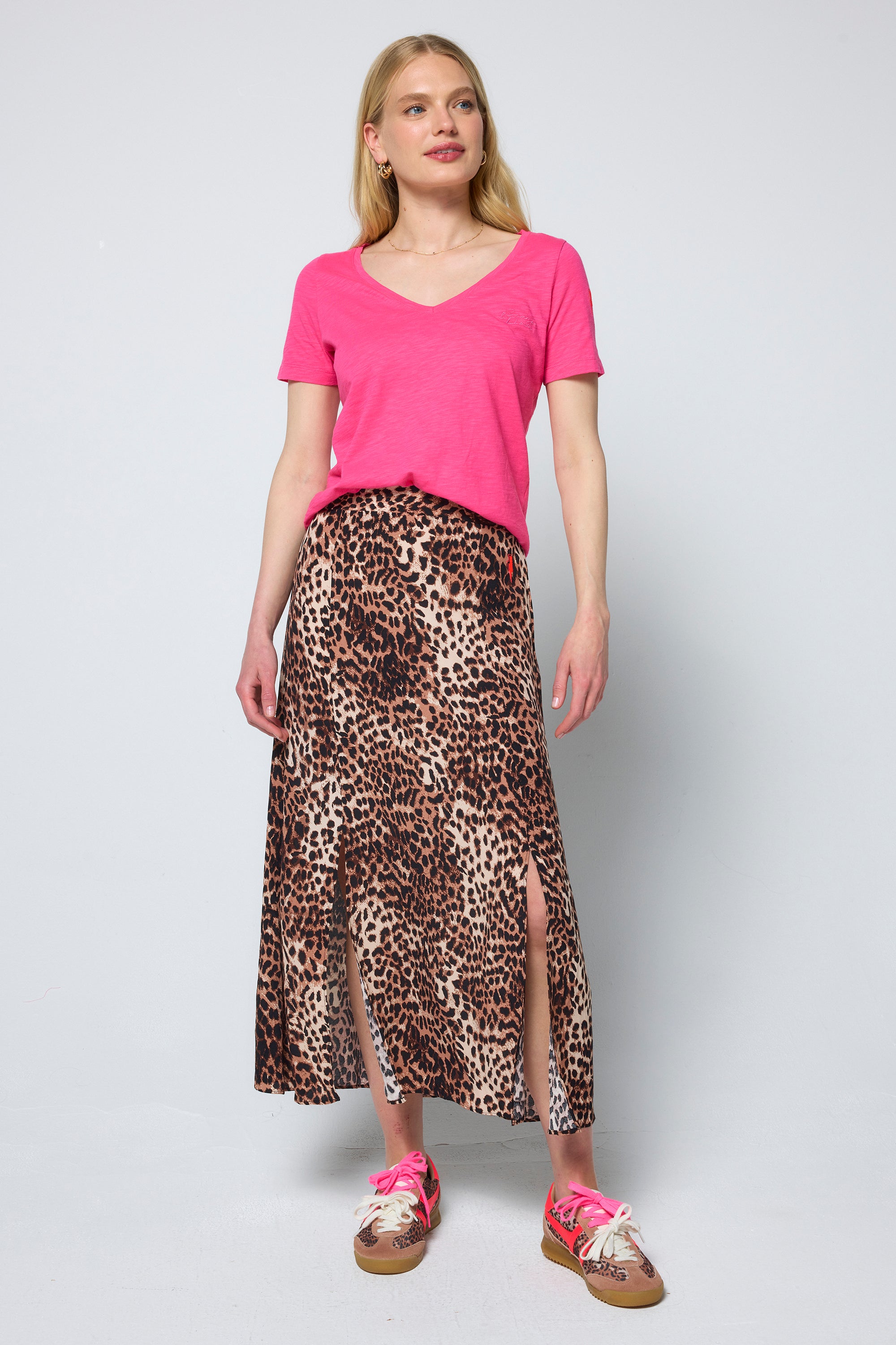 Scamp & Dude Neutral with Black Cheetah Split Front Skirt | Model wearing a pink top and cheetah print skirt on a white background.