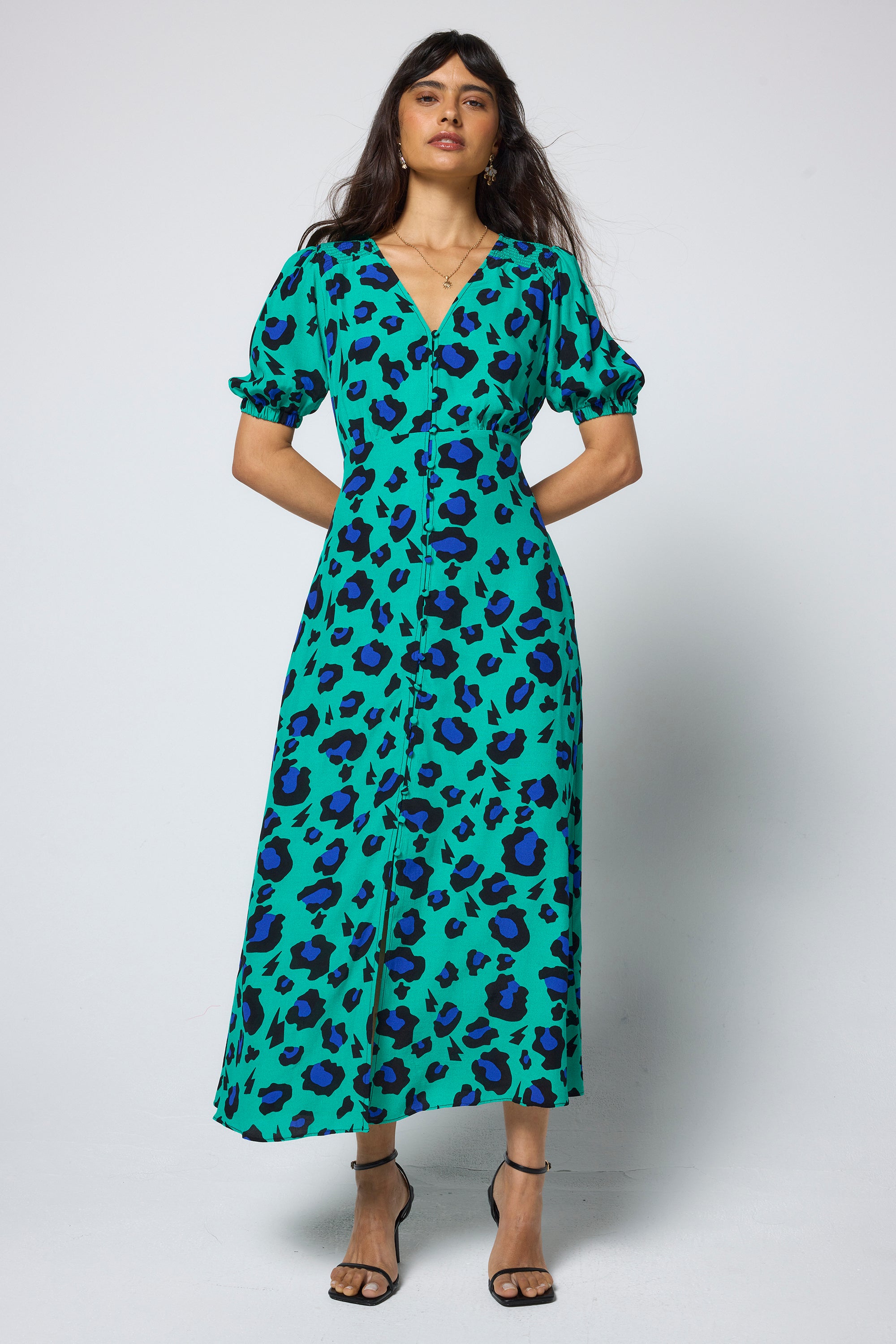 Scamp & Dude Green with Blue and Black Shadow Leopard Blouson Sleeve Midi Tea Dress | Model wearing a green dress with blue and black leopard print on a white background.