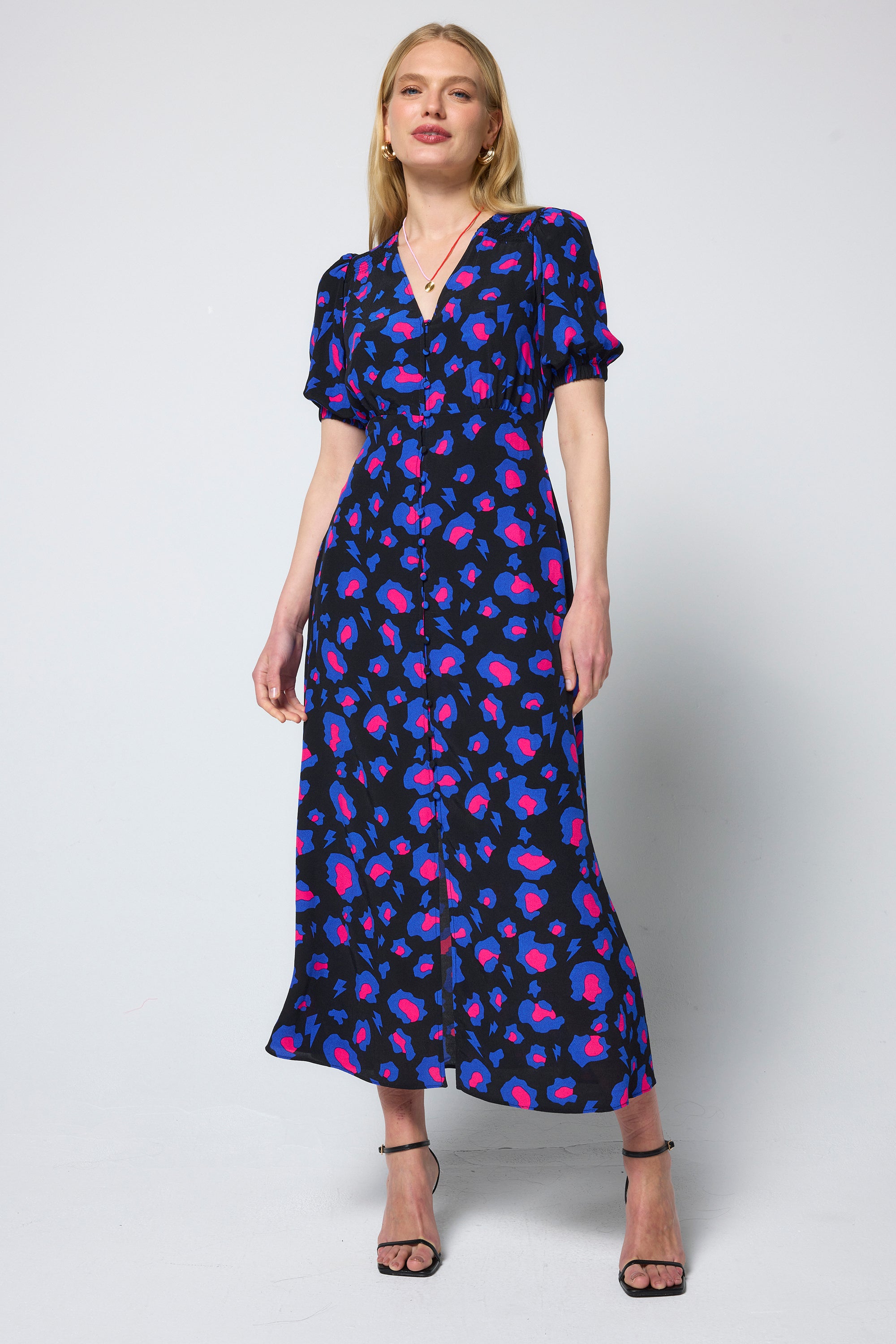 Scamp & Dude Black with Blue and Pink Shadow Leopard Blouson Sleeve Midi Tea Dress | Model wearing a black dress with blue and pink leopard print pattern.