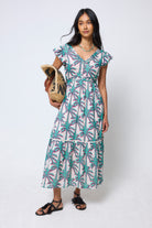 Scamp & Dude Cream with Green Shadow Palm Broderie Sleeve Pintuck Midi Dress | Model wearing a patterned dress holding a woven bag.