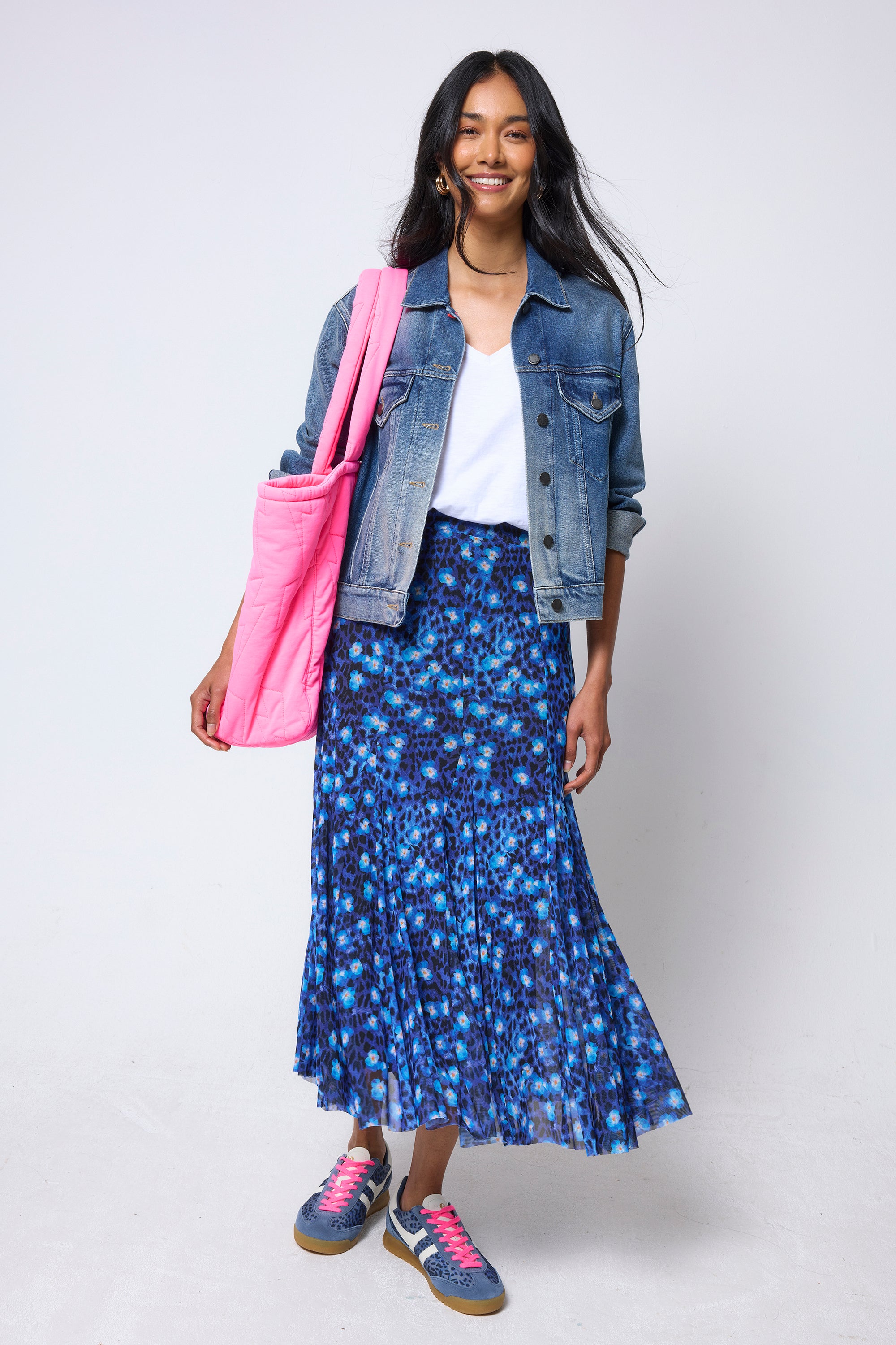 Scamp & Dude Navy Paradise Cheetah Mesh Maxi Skirt | Model wearing a navy floral cheetah print skirt with a white v-neck t-shirt and a denim jacket.