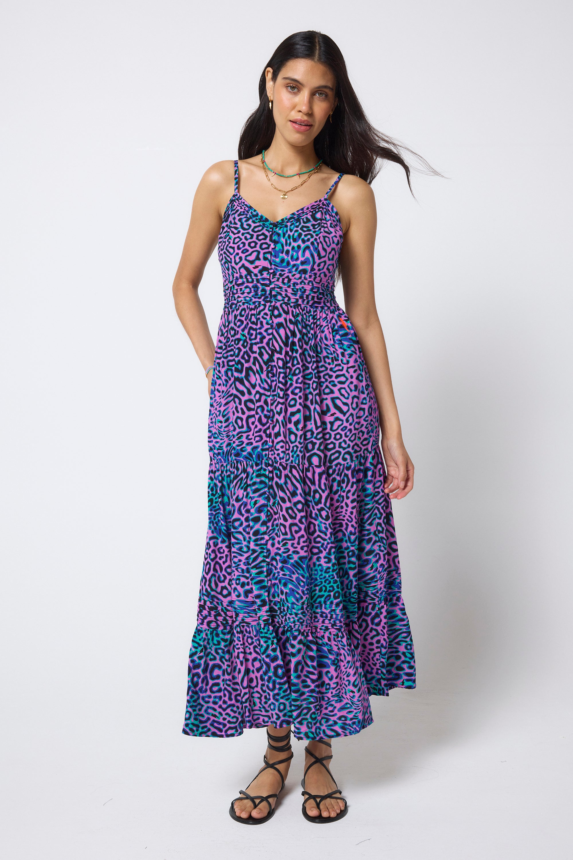 Scamp & Dude Pink with Green Leopard Ray Pintuck Midi Sundress | Model wearing a pink, purple and green patterned dress with black flat sandals.