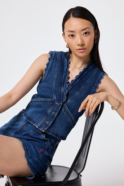 Scamp and Dude Authentic Indigo Scallop Denim Waistcoat | Model wearing a denim waistcoat in an authentic indigo wash with scalloped edge detail paired with matching shorts.