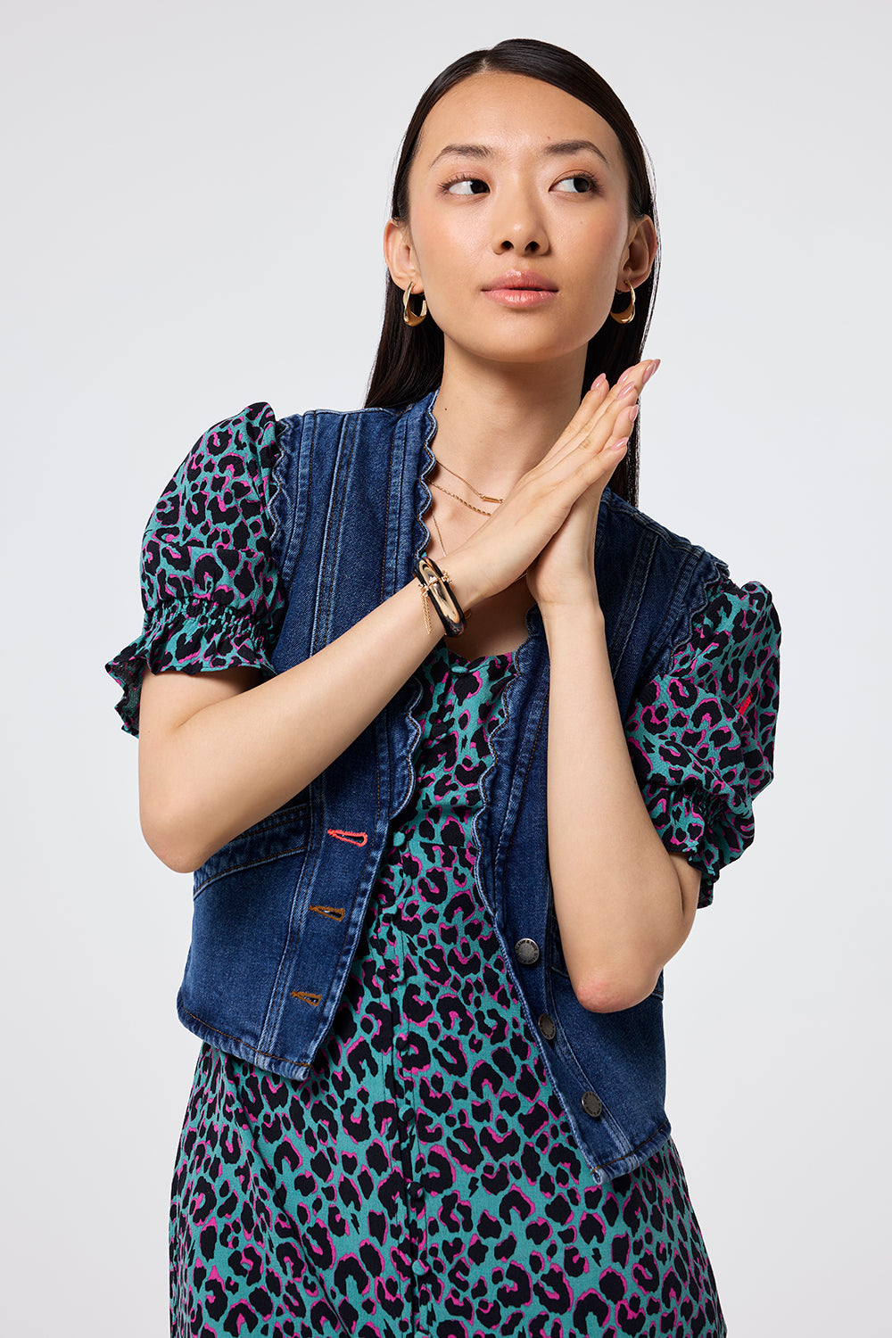 Scamp and Dude Authentic Indigo Scallop Denim Waistcoat | Model wearing a denim waistcoat in an authentic indigo wash with scalloped edge detail layered over a leopard print midi dress.