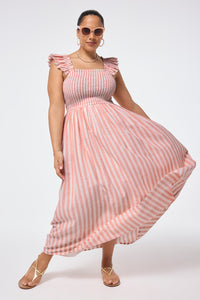 Scamp and Dude Coral with White Stripe Maxi Sundress | Model wearing a striped maxi dress featuring shirring at the bust and ruffle sleeve detail.