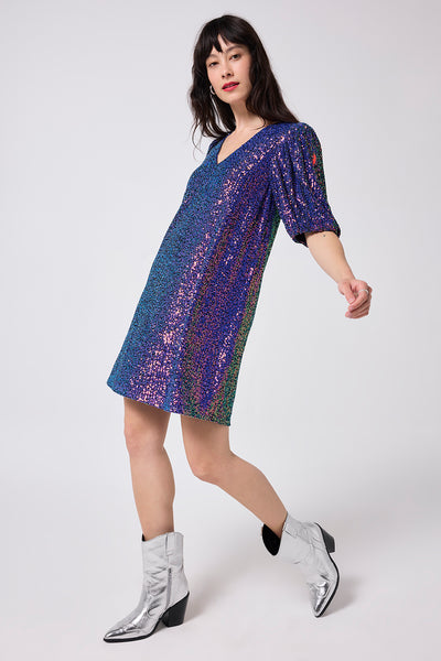 Scamp and Dude Purple Sequin V-Neck Short Dress | Model wearing a short v neck dress in a sequin finish with puff sleeves.