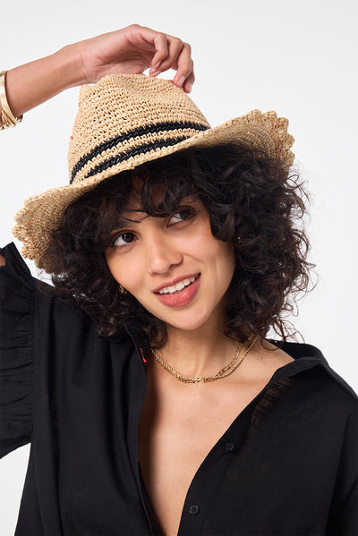Scamp and Dude Natural with Black Stripe Straw Hat | Model wearing a black frill sleeve shirt with a natural straw hat that features a double black stripe detail.