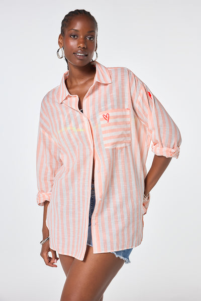 Scamp and Dude Coral and White Stripe Oversized Shirt | Model wearing long sleeve stripe shirt with embroidery detail on the pocket and back.