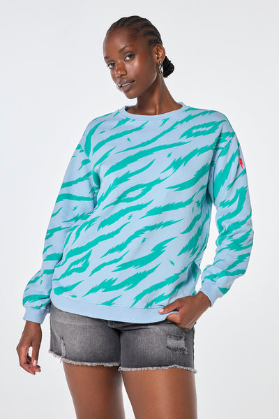 Scamp & Dude Light Blue with Green Graphic Tiger Oversized Sweatshirt | Model wearing light blue crew neck sweatshirt with green graphic tiger print in an oversized fit.