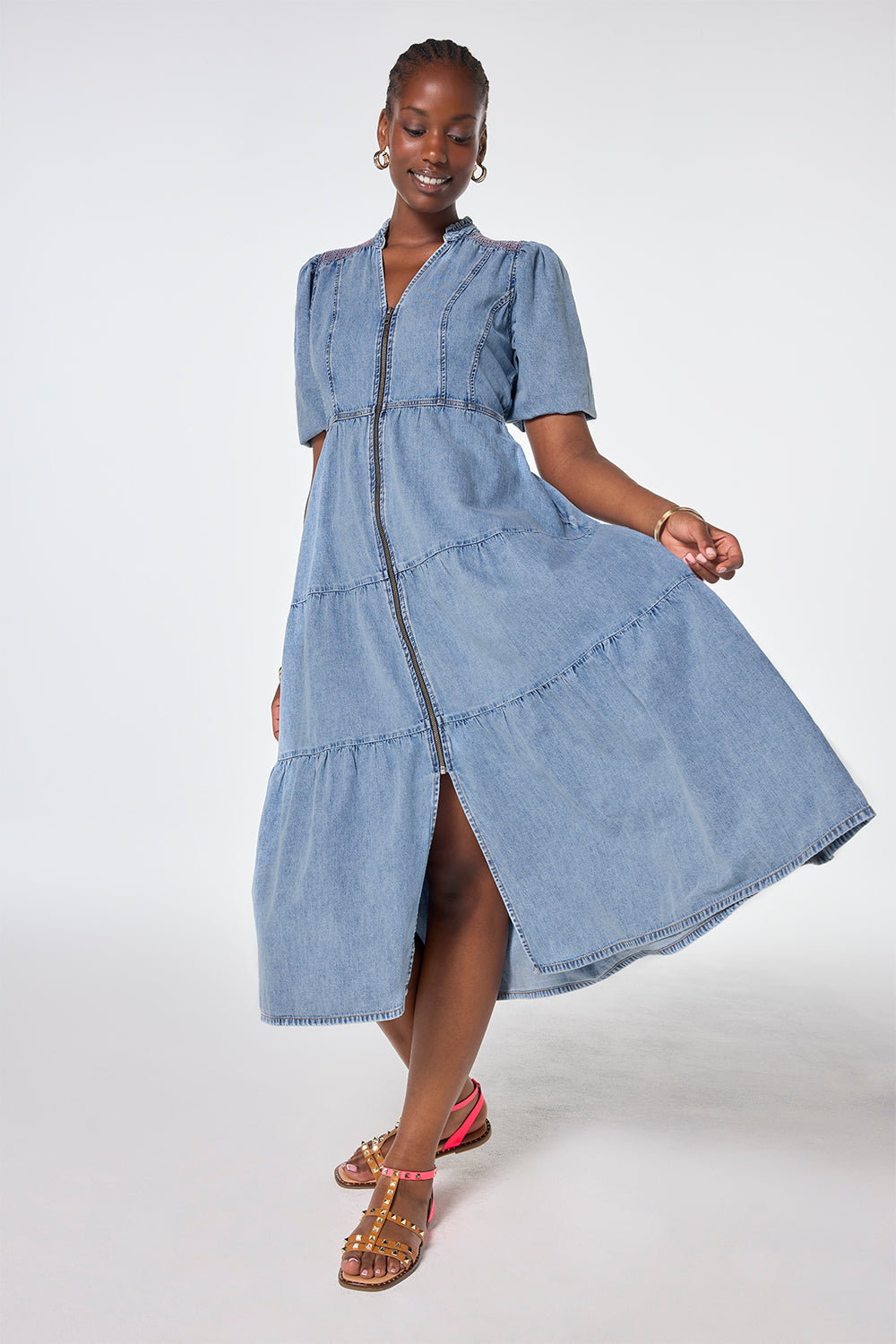 Scamp and Dude Pale Indigo Zip Detail Tiered Midi Denim Dress | Model wearing a pale wash denim dress with a zip through front and tiered skirt.