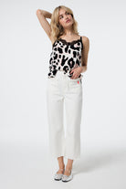 Scamp and Dude Ecru Cropped Wide Leg Jeans | Model wearing cropped wide leg jeans in an ecru finish paired with a cami top featuring a lace trim.