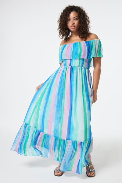 Scamp and Dude Rainbow Stripe Bardot Maxi Dress | Model wearing a bardot maxi dress in a rainbow painted stripe with lurex detail.