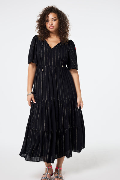 Scamp and Dude Black with Silver Lurex Angel Sleeve Tie Front Maxi Dress | Model wearing a black short sleeve tie front maxi dress with silver lurex stripe detail.