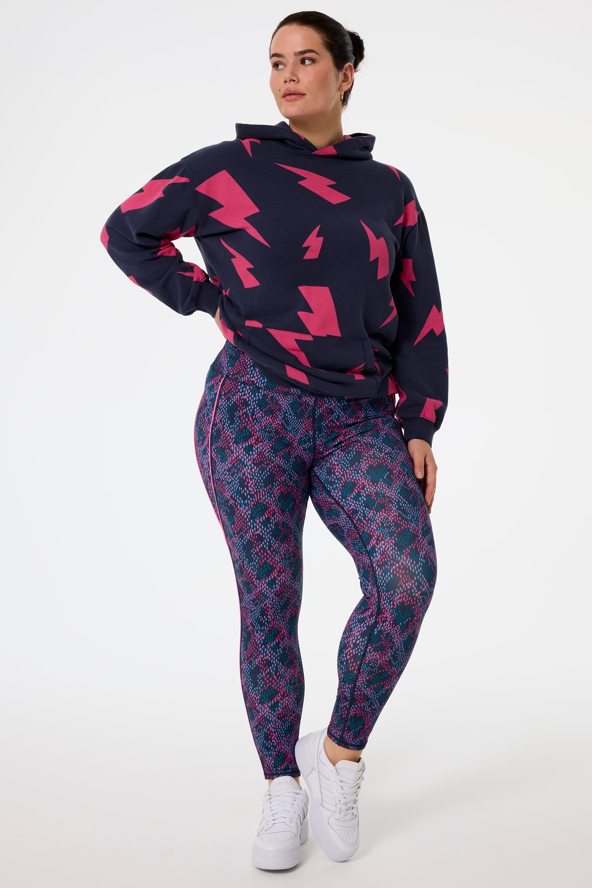 Scamp and Dude Navy with Pink and Lilac Lightning Bolt Snake Print Full Length Active Leggings | Model wearing navy hoodie pink mega lightning bolts paired with navy with pink and lilac lightning bolt snake print leggings.