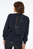 Scamp and Dude Washed Black with Studded Lightning Bolt Oversized Sweatshirt | Model wearing a sweatshirt with a glitter lightening bolt details.