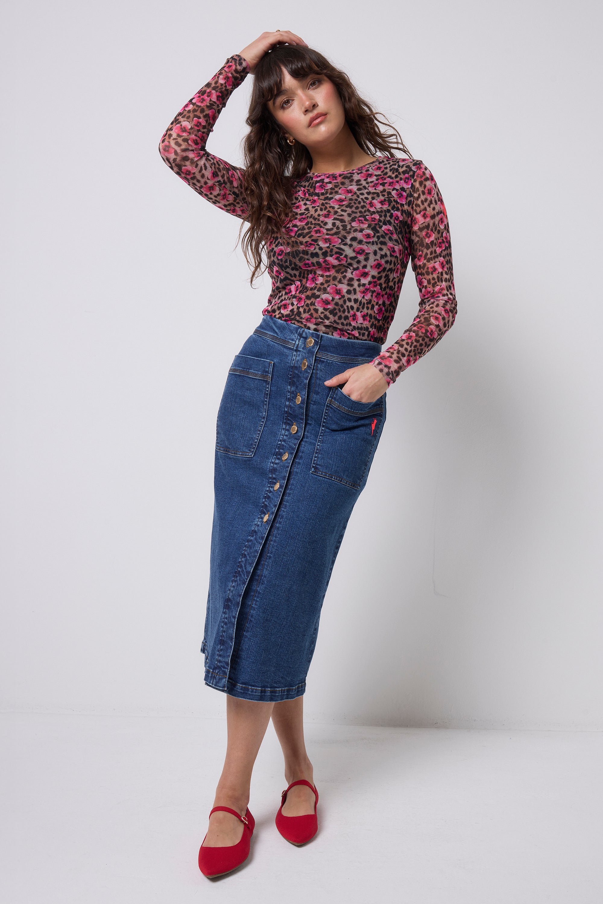 Scamp & Dude Neutral Paradise Cheetah Printed Mesh Top | Model wearing a floral cheetah print mesh top and dark blue button through denim skirt.