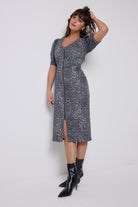 Scamp & Dude Washed Navy Wild Cheetah Denim Zip Front Midi Dress | Model wearing a cheetah print zip front denim dress with black boots.