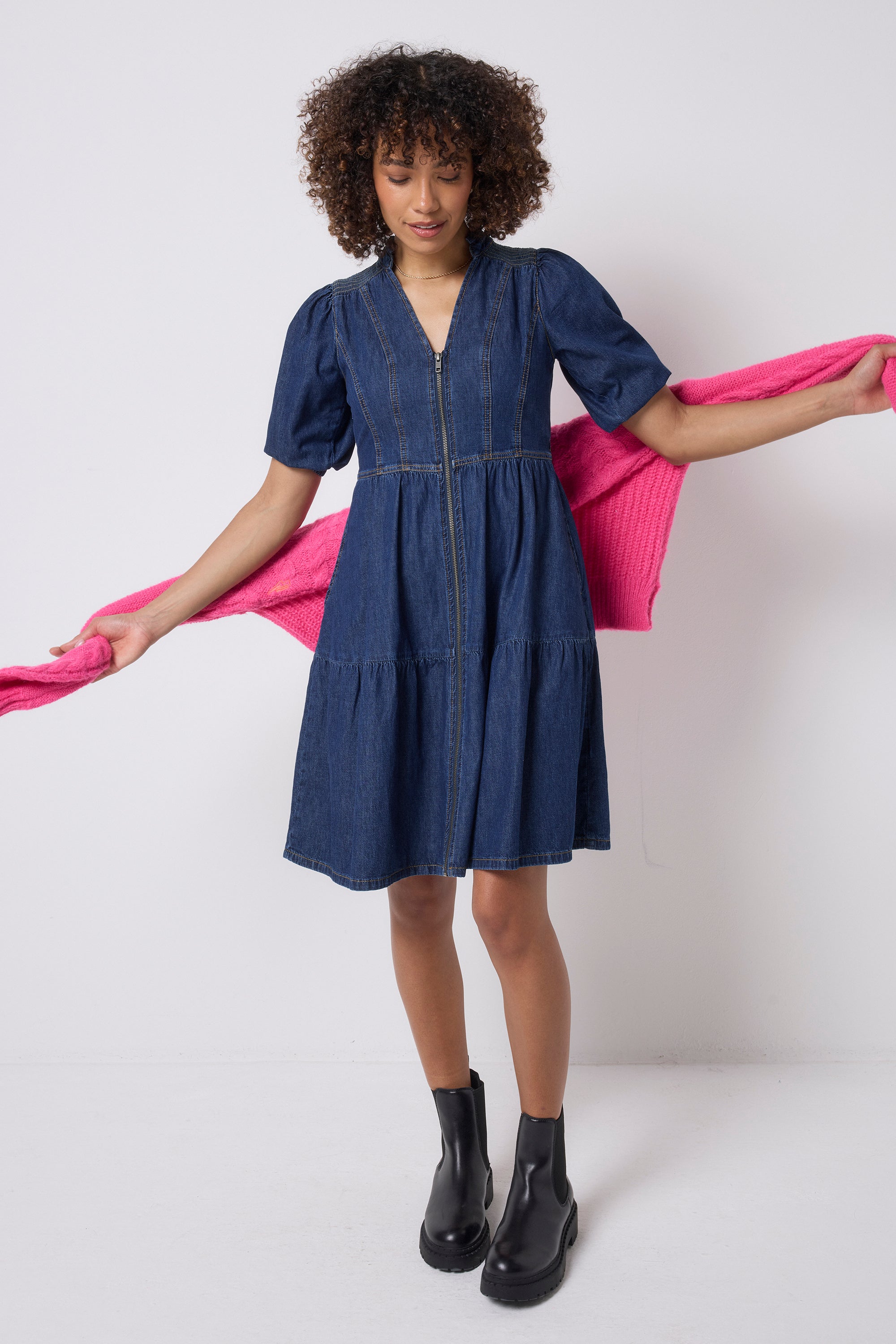Scamp and Dude Authentic Indigo Zip Detail Tiered Short Denim Dress | Model wearing a blue short denim zip front dress with black boots.