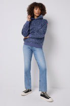 Scamp and Dude Blue Leopard Ray Relaxed Hoodie | Model wearing a blue hoodie with a leopard ray print. Paired with blue jeans and black trainers.