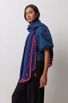 Scamp & Dude Navy Charity Super Scarf | Model wearing a denim top with black joggers and a navy super scarf.