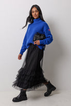 Scamp & Dude Black Tulle Skirt | Model wearing a black tulle skirt with a blue turtleneck and black boots.