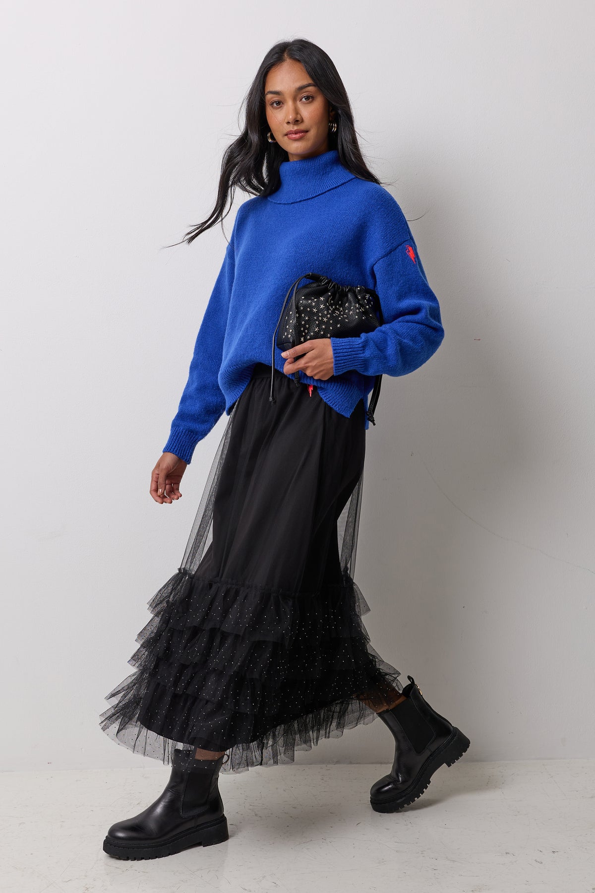 Scamp & Dude Black Tulle Skirt | Model wearing a black tulle skirt with a blue turtleneck and black boots.
