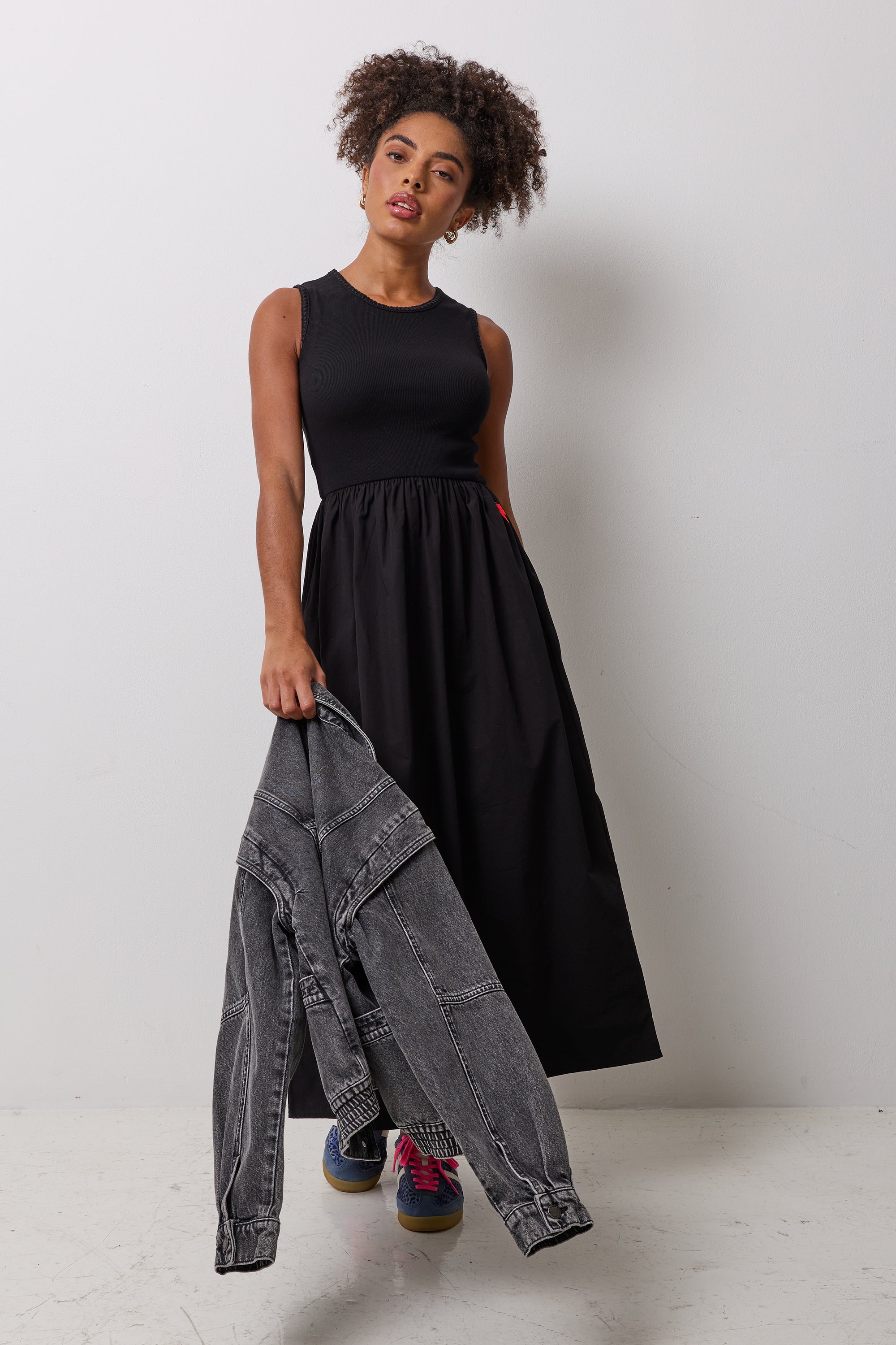 Scamp & Dude Black Jersey Woven Mix Midi Dress | Model wearing a black midi dress with a black denim jacket.