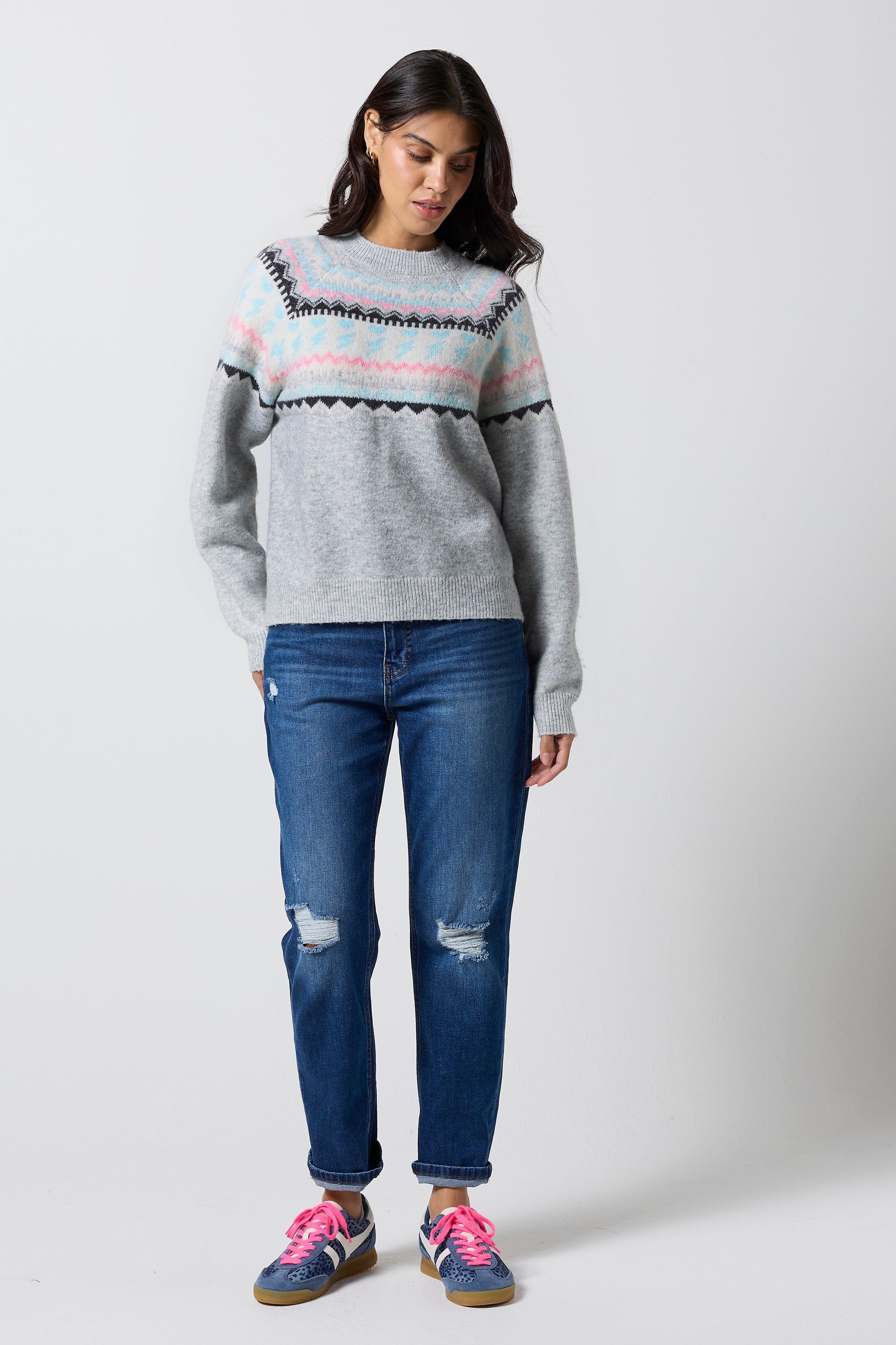 Scamp & Dude Grey Marl Fairisle Knit Jumper | Model wearing a long sleeve grey fairisle knit jumper with a pair of distressed denim jeans and navy cheetah print trainers.
