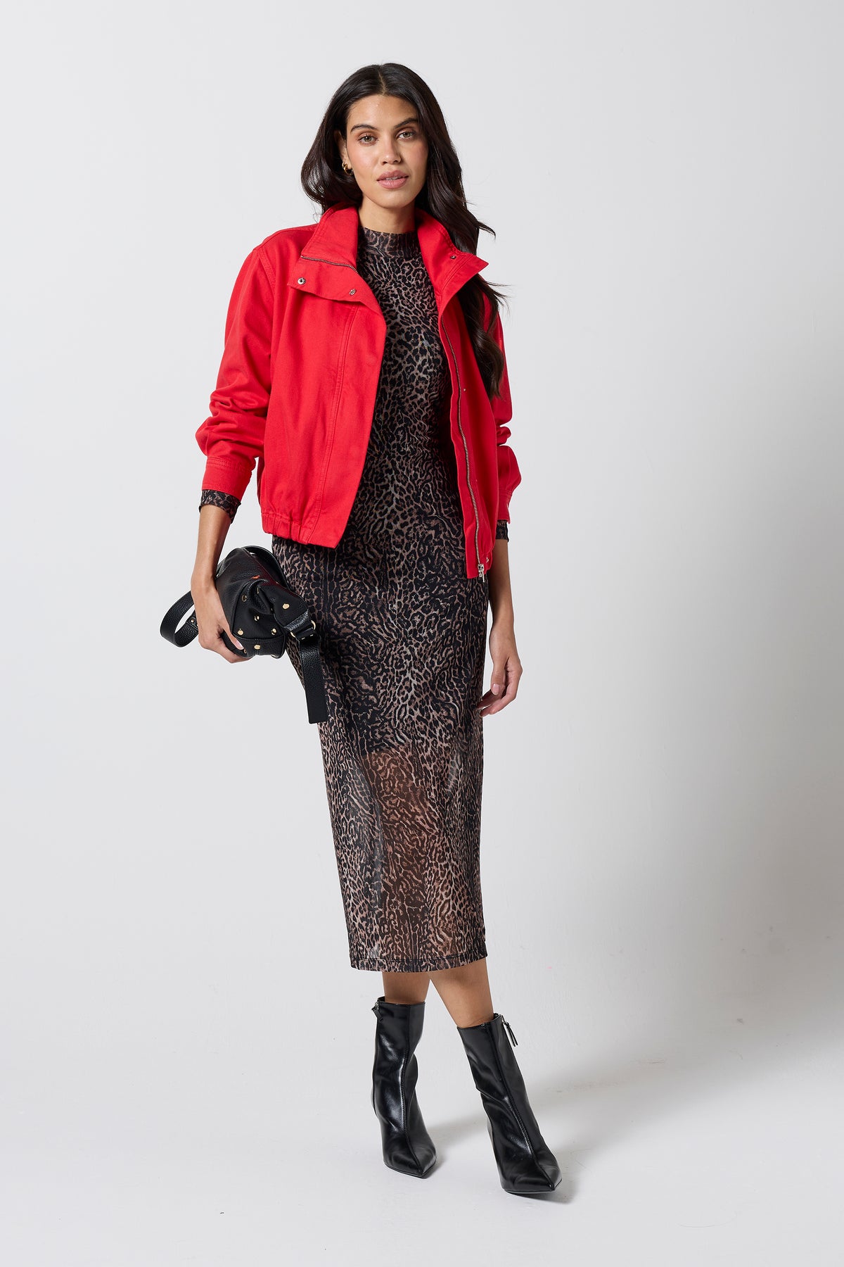 Scamp & Dude Red Denim Bomber Jacket | Model wearing a neutral mesh print dress with a red denim bomber jacket and black heeled boots.