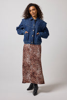 Scamp & Dude Mid Wash Seam Detail Denim Jacket | Model wearing a cropped blue denim jacket and a brown leopard-print midi dress, paired with black ankle boots.