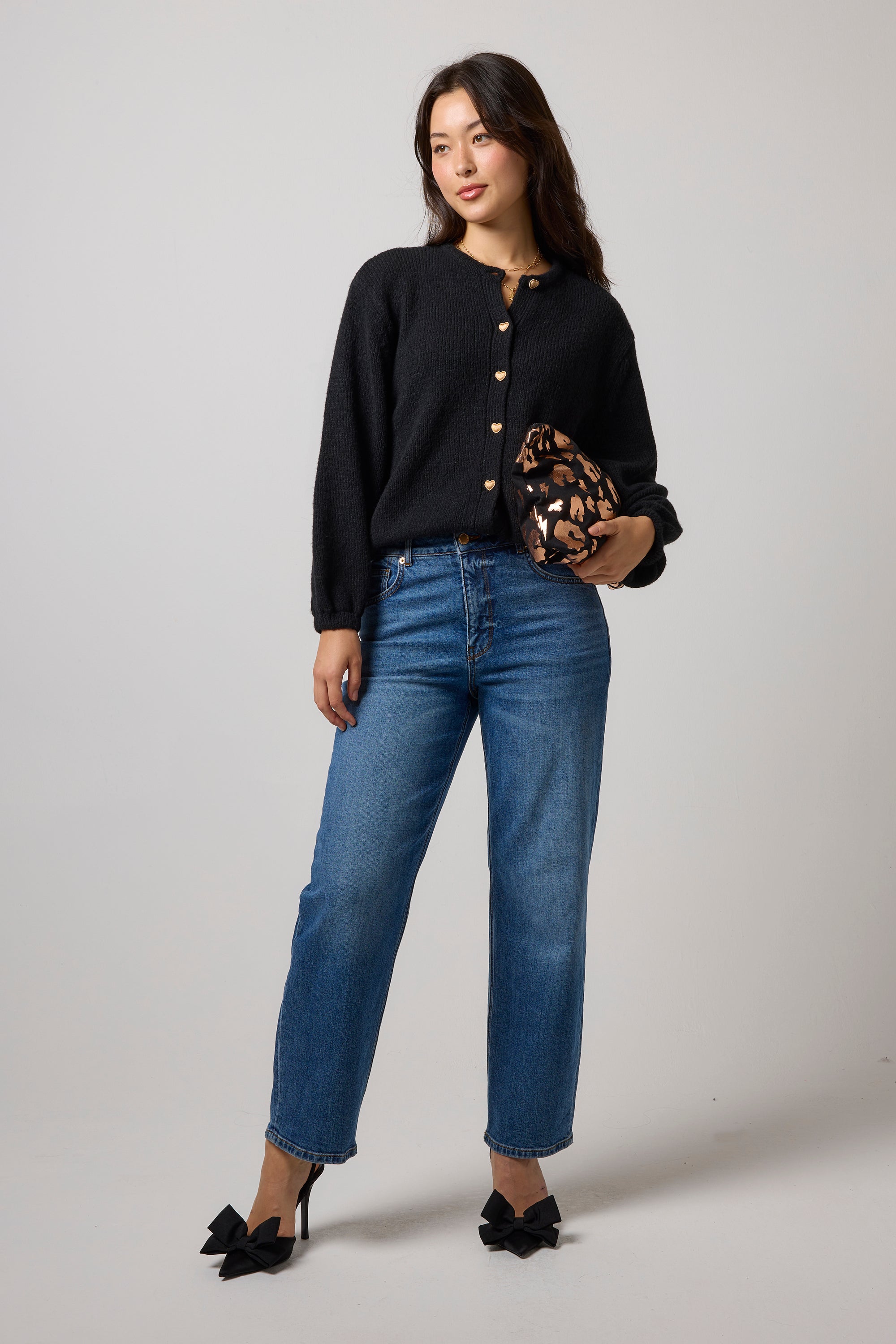 Scamp & Dude Black Long Sleeve Cardigan | Model wearing long sleeve black cardigan with a pair of blue jeans.