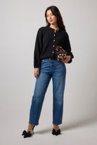 Scamp & Dude Black Long Sleeve Cardigan | Model wearing long sleeve black cardigan with a pair of blue jeans.