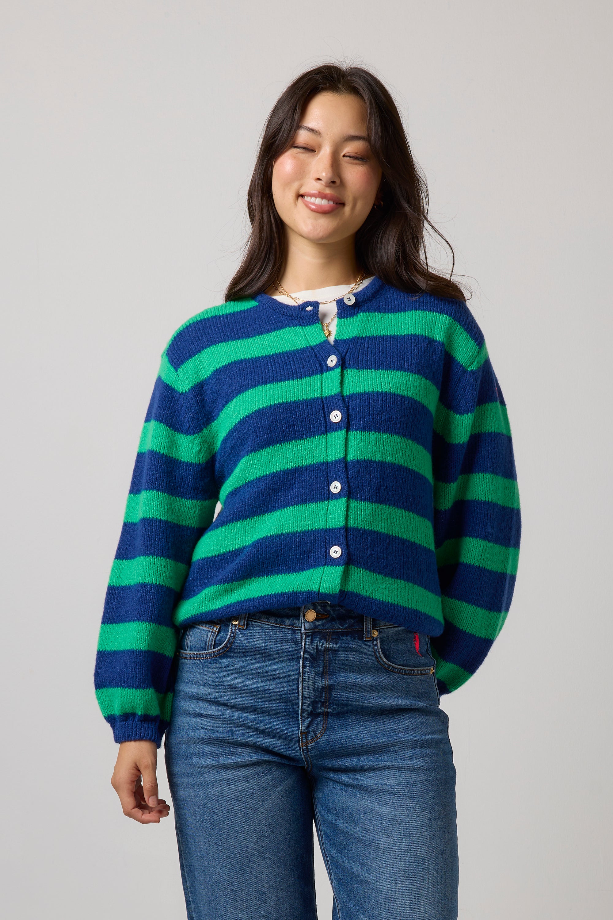 Scamp & Dude Navy with Green Stripe Cardigan | Model wearing a stripe cardigan, white t-shirt and a pair of blue jeans.