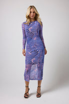 Scamp & Dude Blue Tiger Moth Mesh Midi Dress | Model wearing a mesh midi dress in a tiger moth print with black strappy heels.
