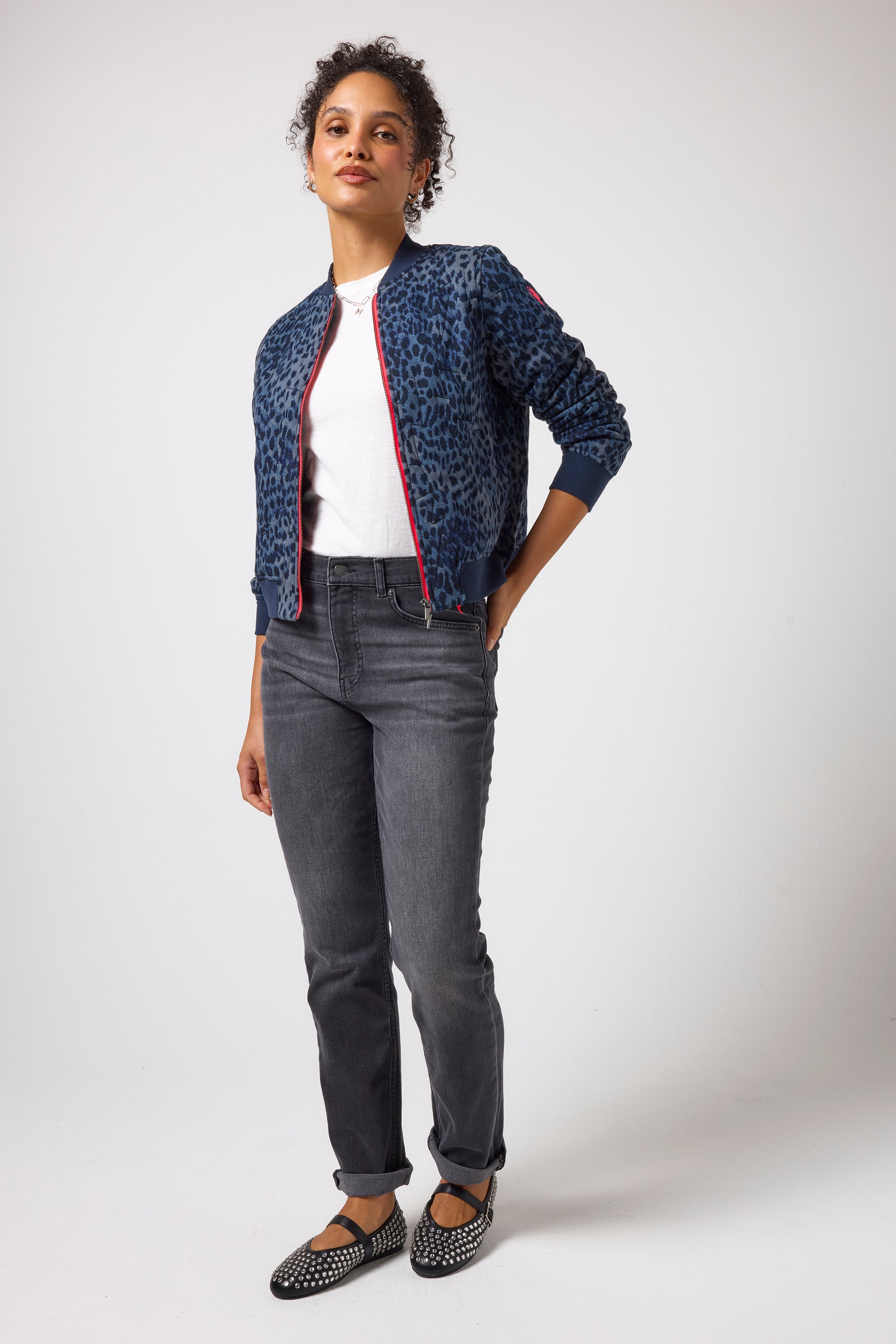Scamp & Dude Navy Cheetah Fitted Bomber Jacket | Model wearing a pair of black boyfriend jeans with a white t-shirt and navy cheetah print bomber jacket.
