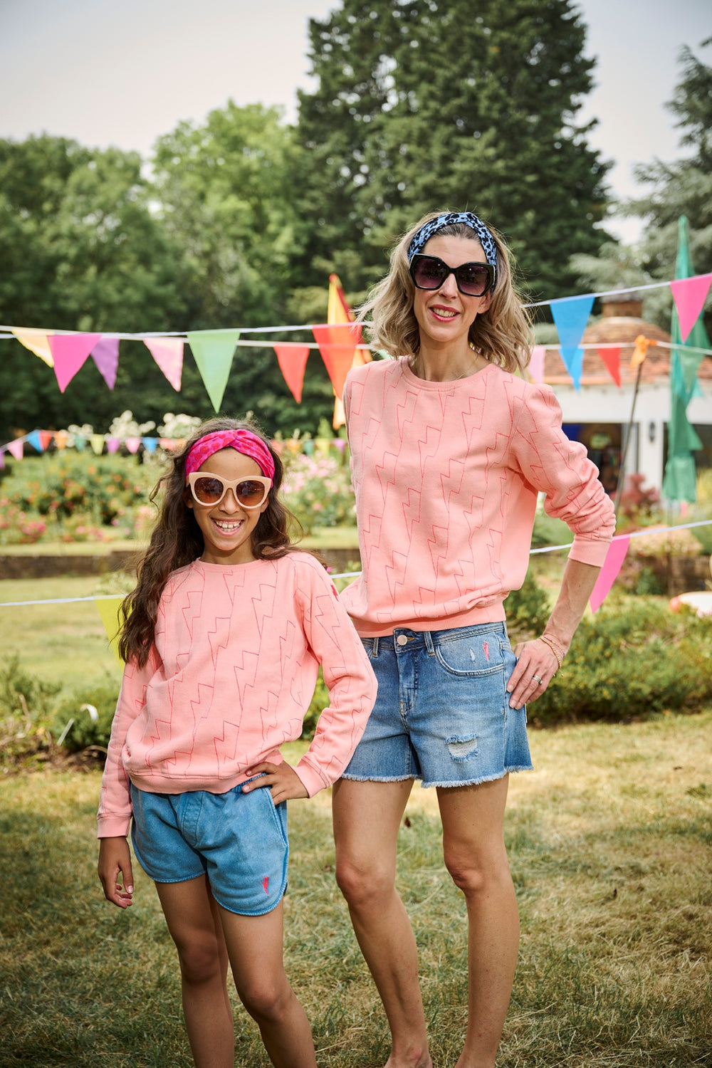 A woman and child wearing colourful Scamp & Dude headbands and matching sweatshirts