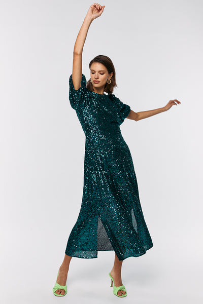 Scamp and Dude Green Sequin Puff Sleeve Midi Dress | Model with hands up in the air wearing a green sequin dress with bright green high heels