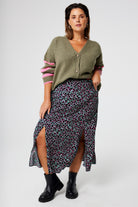 Scamp and Dude Khaki with Pink and Black Small Shadow Leopard Split Front Skirt | Model wearing a green cardigan with khaki midi skirt featuring pink and black small shadow leopard print.