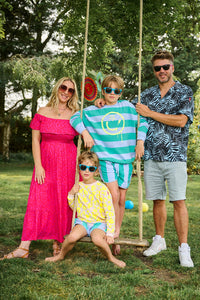 Jo outside with her family wearing a magenta with hot pink floral leopard bardot midi dress