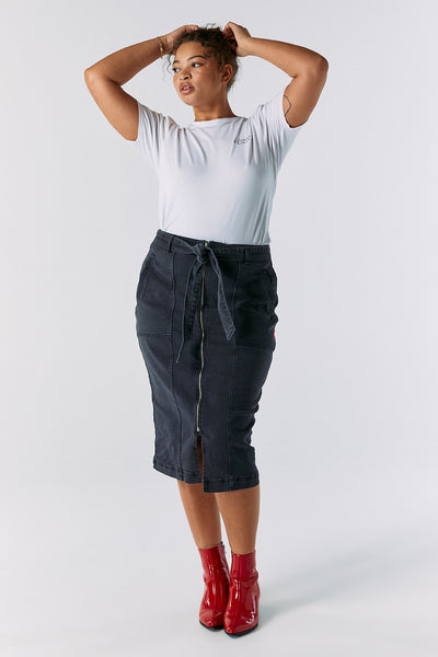 Scamp and Dude Washed Black Zip Detail Denim Midi Skirt | Model with hands in hair wearing a plain white t-shirt with black midi denim skirt and red boots 
