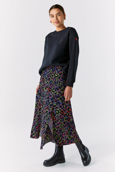 Scamp and Dude Navy Long Sleeve Jumper | Model wearing dark navy jumper with dark blue and neon pink and yellow leopard print skirt
