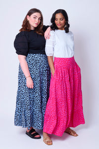 Two women wearing floral leopard print maxi skirts in different colourways with pintuck T-shirts tucked in