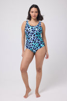 Scamp and Dude Turquoise with Black and Blue Shadow Leopard Scallop Edge Swimsuit | Model wearing a turquoise swimsuit with blue and black leopard print, featuring a scallop trim.